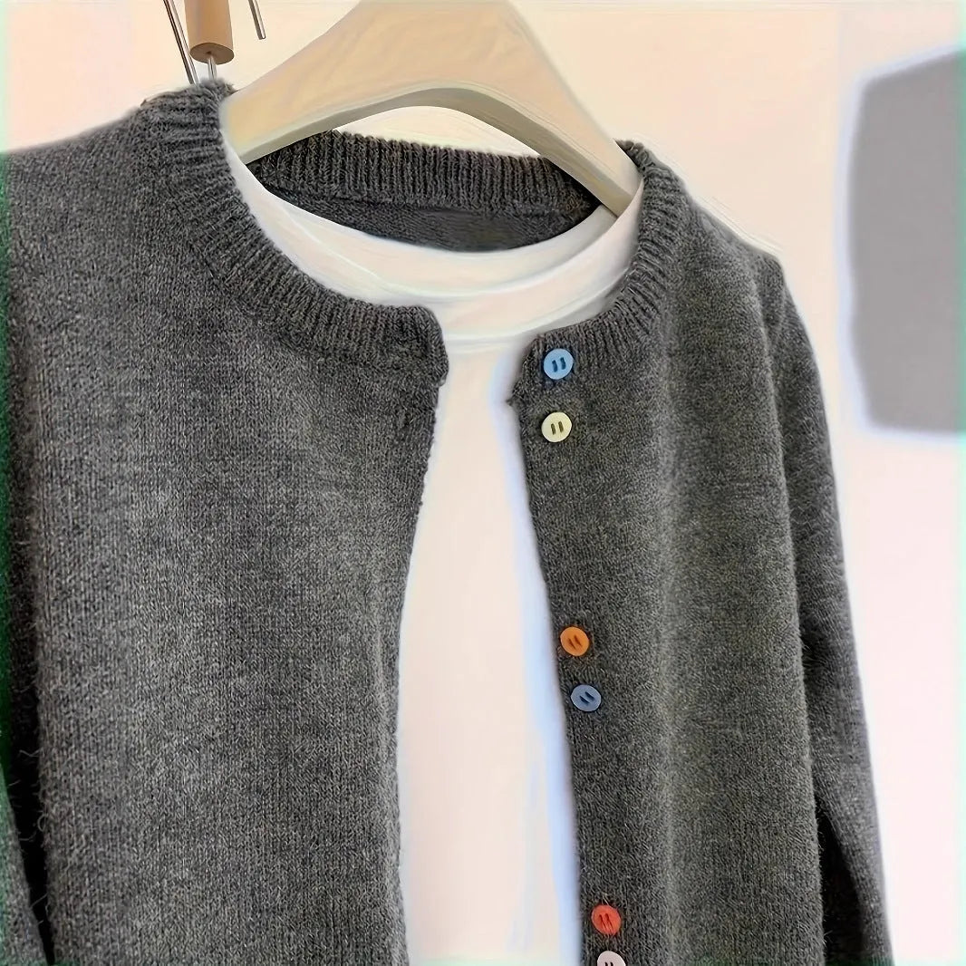 Dark grey solid colour women's polyester cardigan sweater with button front and long sleeves.
