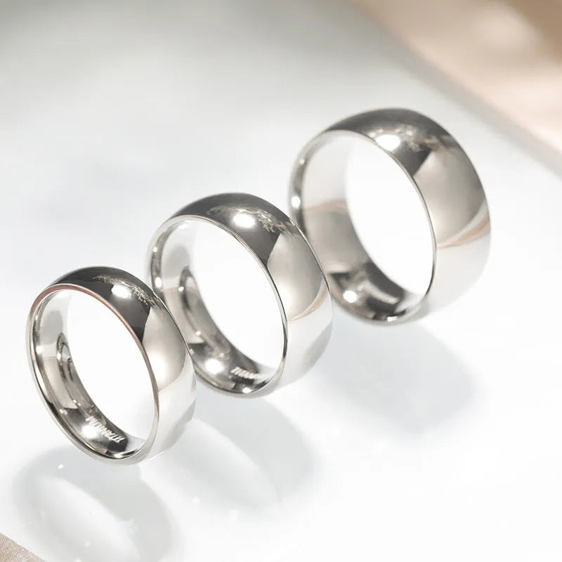 Simple silver titanium steel band ring shown in three width options: 2mm, 4mm, and 6mm.