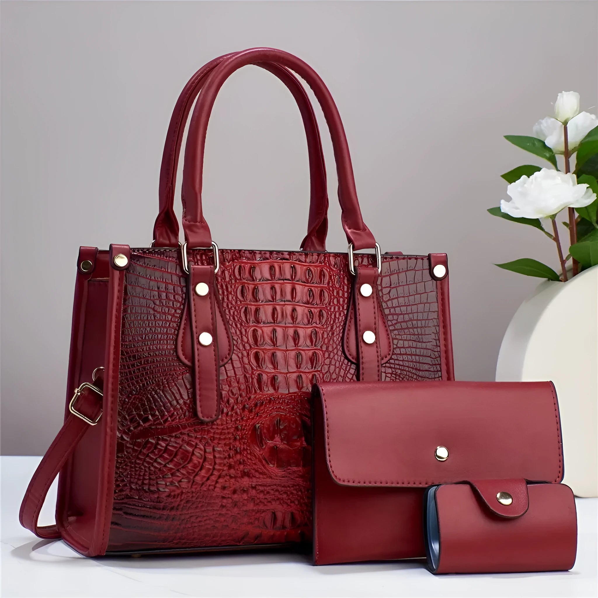 PU leather three-piece bag set showing bucket crossbody bag, wallet and card holder with contrast trim in burgundy colour