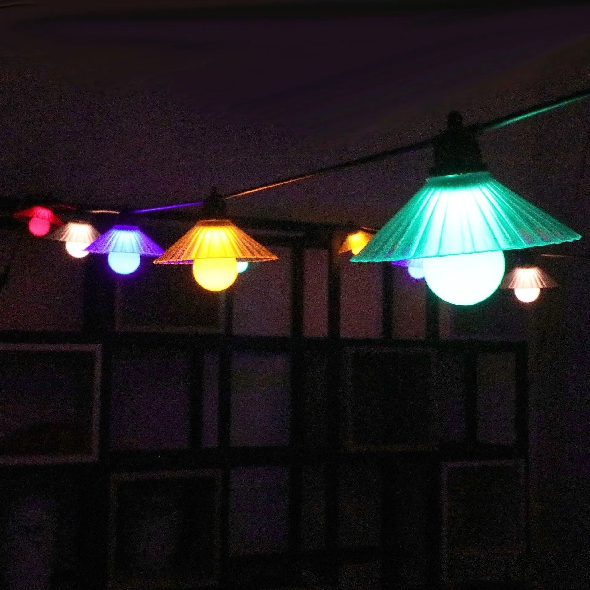 Outdoor LED string lights with flower-shaped bulbs showing warm white and coloured lighting options
