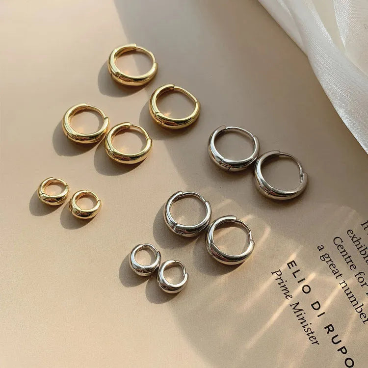Geometric water drop earrings in gold or silver on a copper base, shown in small, medium, and large sizes.