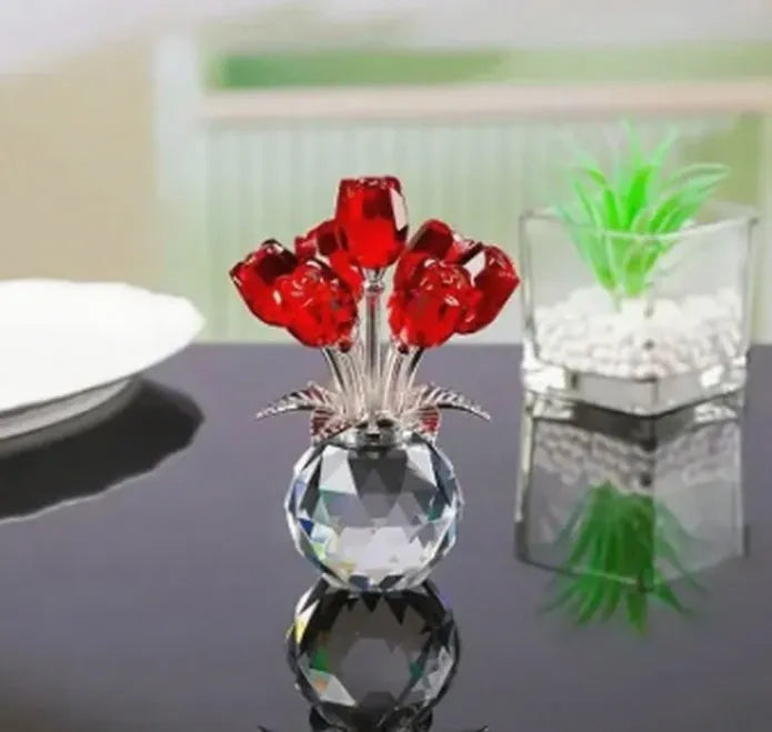 Geometric crystal glass rose ornament in red colour on wooden surface
