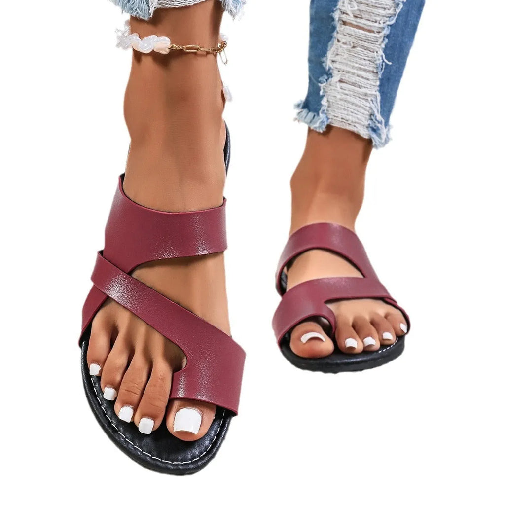 Adult casual beach slipper in black with hollow out design and rubber sole.