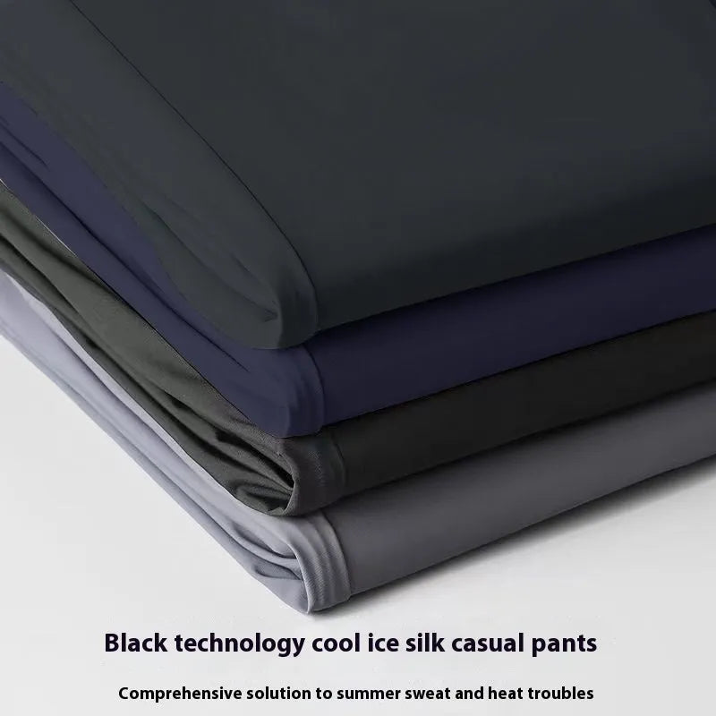 Man wearing black loose-fit ice silk straight leg casual trousers.