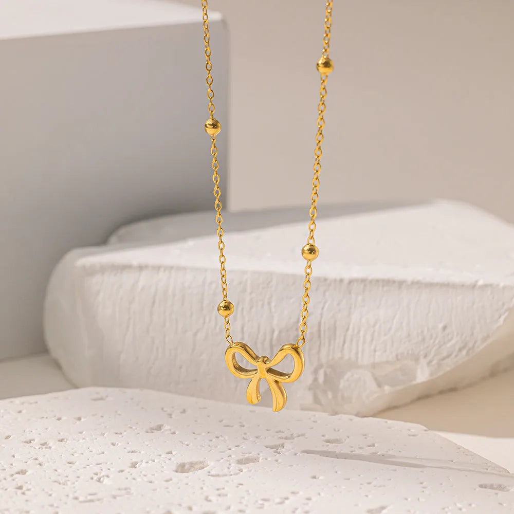 Gold titanium steel bow necklace with cross chain style for women