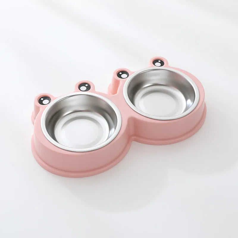 Frog-shaped plastic holder containing two stainless steel pet bowls for food and water.