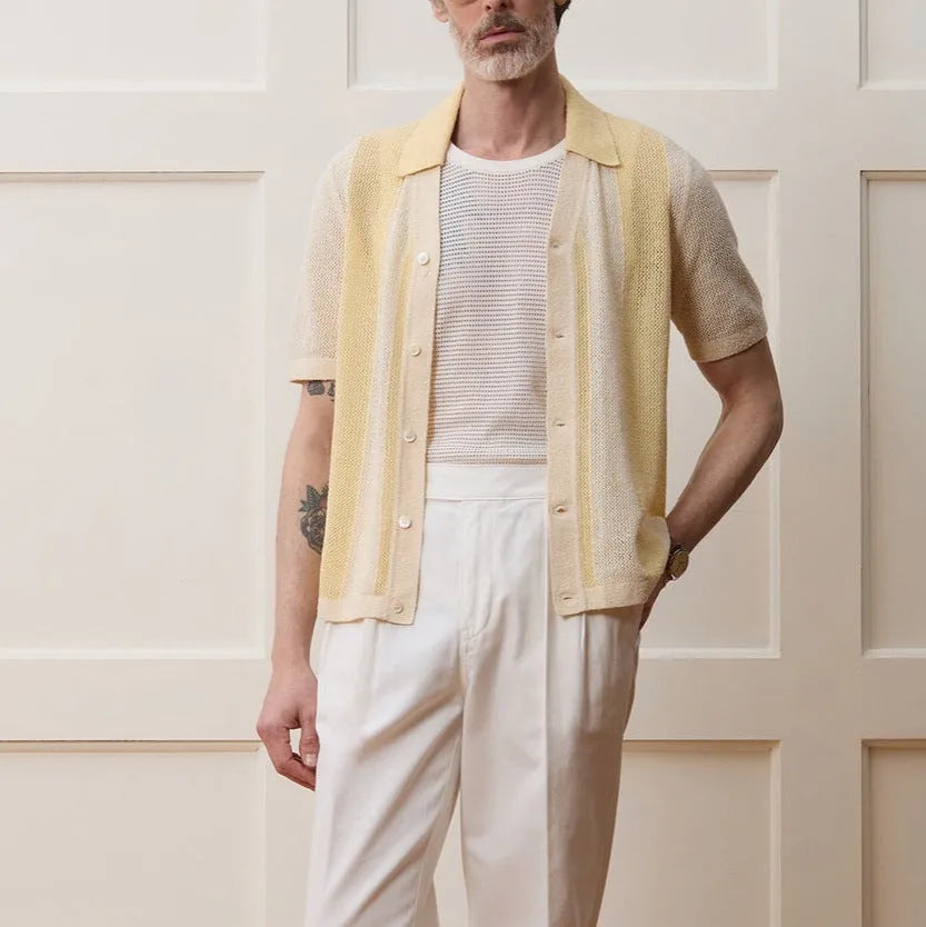 Yellow men's casual polo shirt with hollow-out detailing and an asymmetric short sleeve hem.