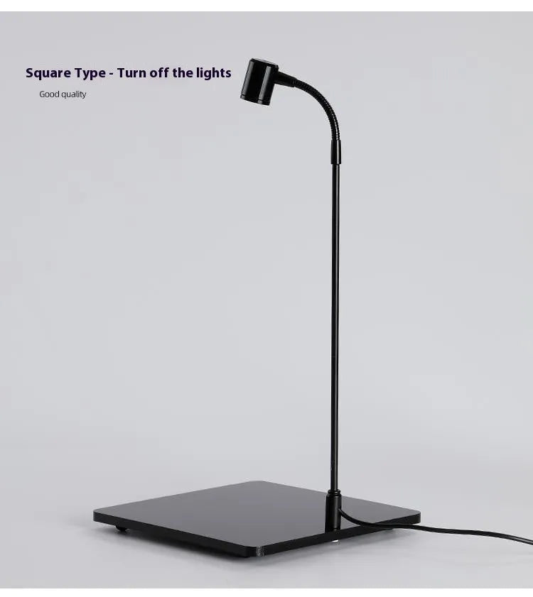 LED moss plant lamp with copper body, USB cable, round base white light, on a desk near a small acrylic fish tank