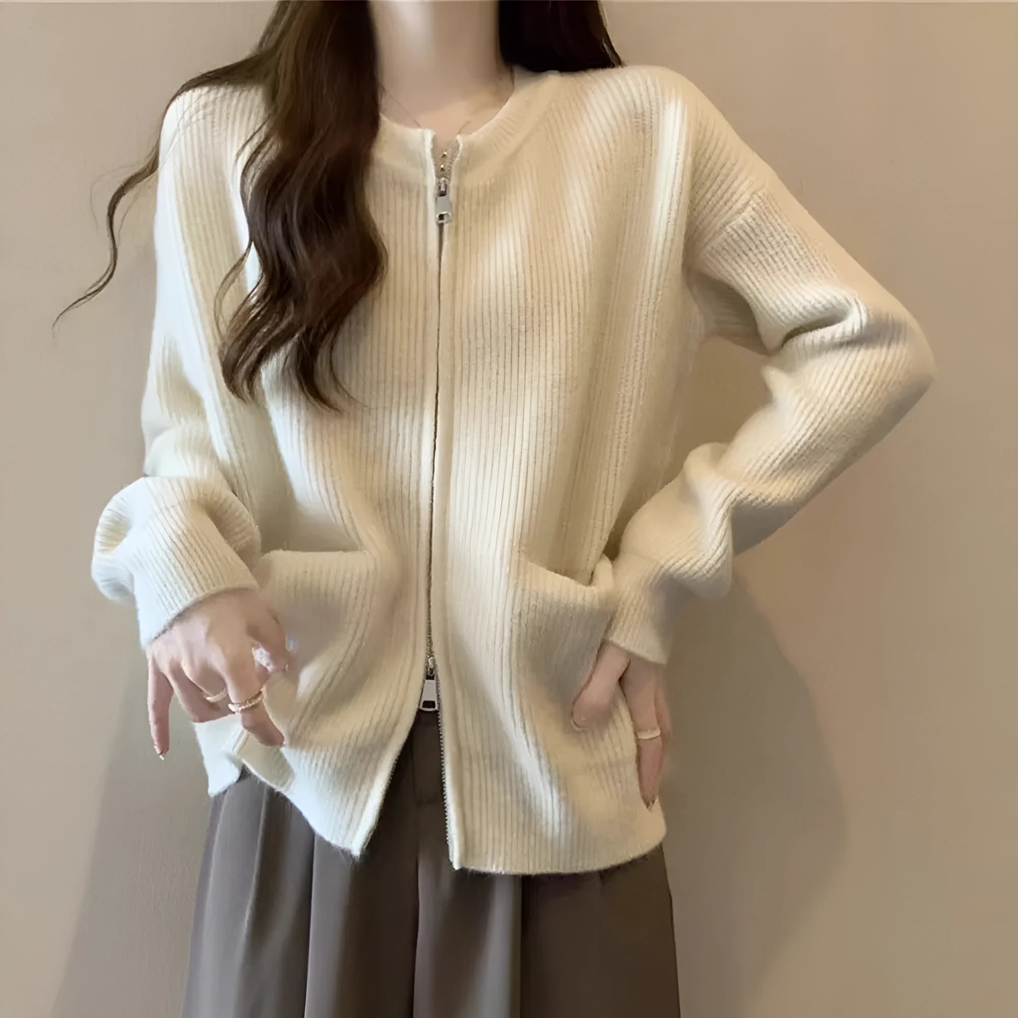 Beige women's long sleeve soft glutinous sweater coat cardigan laid flat.