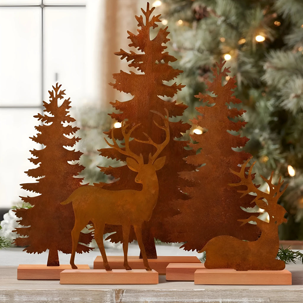 Set of three rusty iron elk and Christmas tree metal ornaments on a wooden surface.