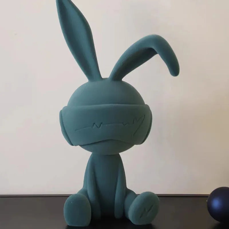 Green suede blindfold rabbit resin table ornament on wooden surface