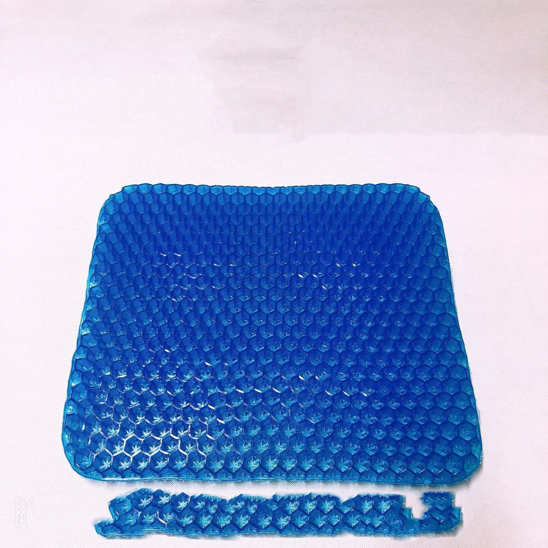 A blue breathable honeycomb gel seat cushion with a removable cover, shown on a wooden chair.