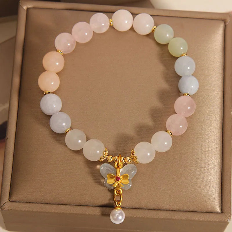 Women's colourful Morgan stone butterfly pendant crystal bracelet on wrist.