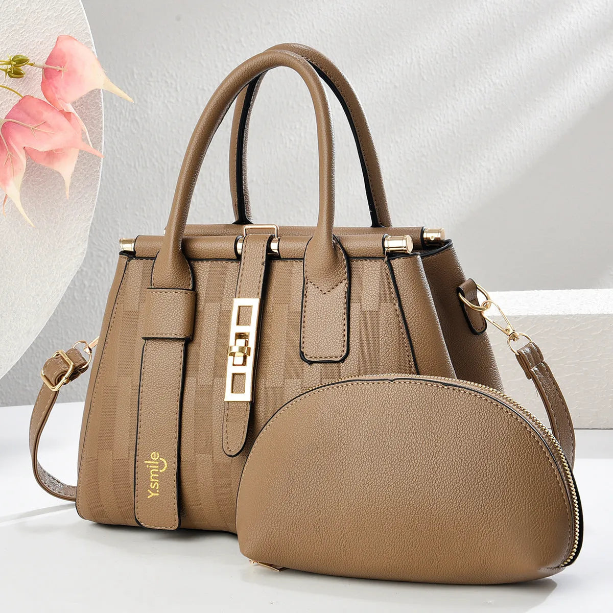 Round black PU handbag with crossbody strap shown alongside light khaki and purplish red colour options