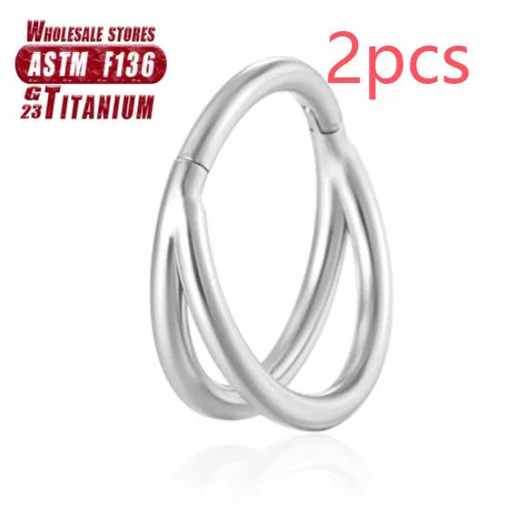 Close-up of a titanium alloy nose ring with a fork closure, shown in silver finish on a grey background.