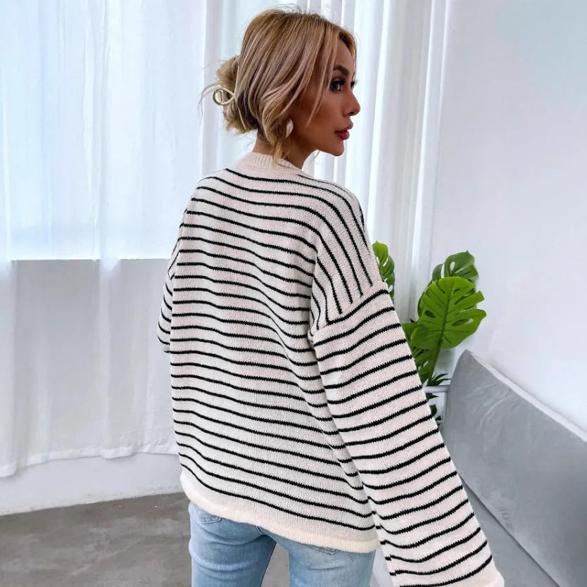 Black and white striped women's loose-fit long sleeve top with drop shoulders and button front.