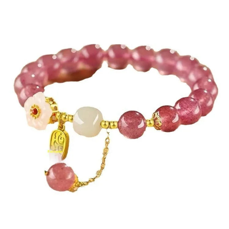 Handmade women's bracelet with strawberry quartz beads and Hetian jade peach blossom details.