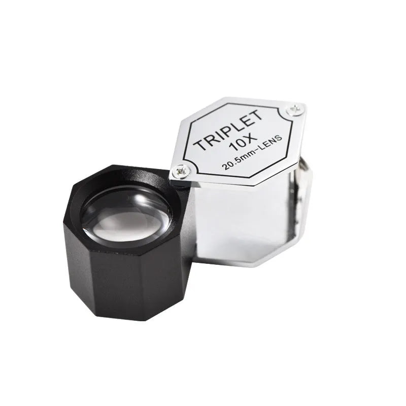 Handheld portable magnifying glass for jewellery and coin inspection with metal frame.