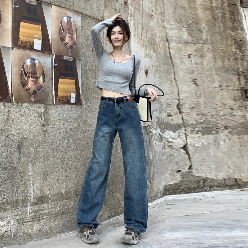 Women's high-waisted retro straight jeans in medium blue denim, showing straight leg and high waist silhouette.