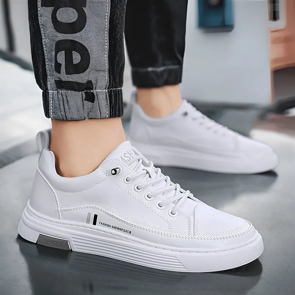 Men's white low-top skate shoes with a microfiber upper and elastic band, shown on a grey background.
