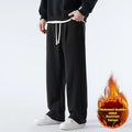 Men's double-sided polar fleece sports trousers in apricot, showing loose fit and drawstring waist.