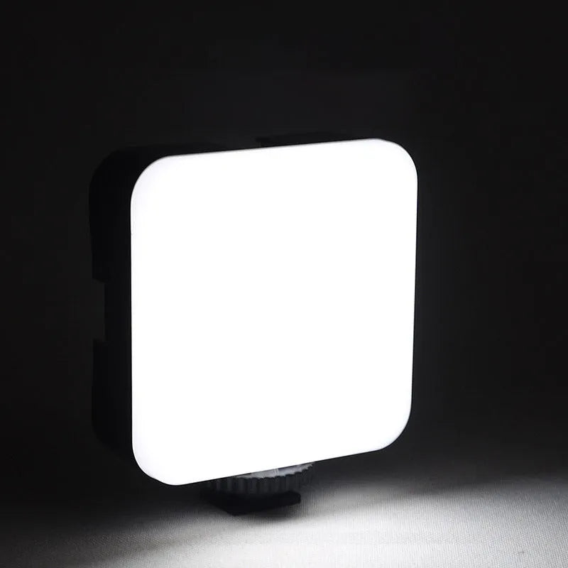 Universal LED mini square camera flash with rotatable head on a tripod stand.