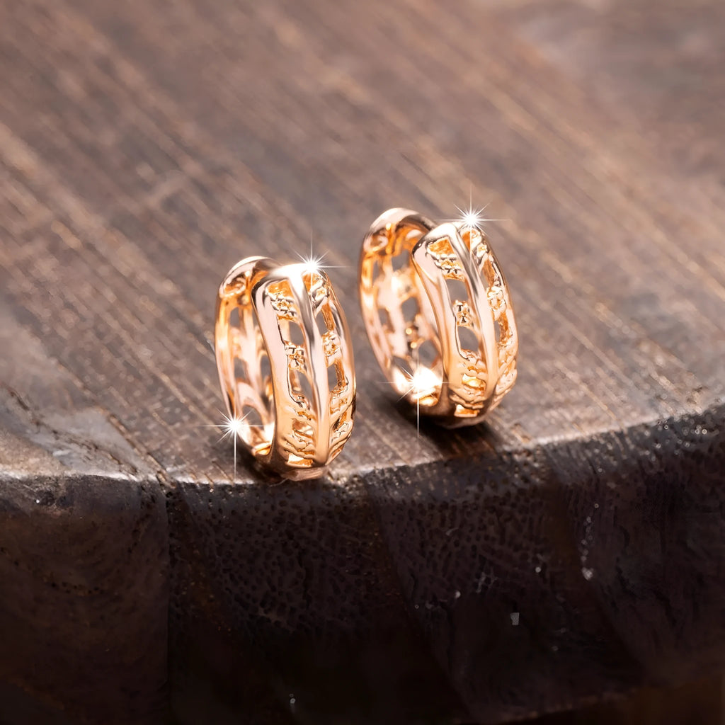 Rose gold hollowed copper earrings in leaf and heart shapes on a white background