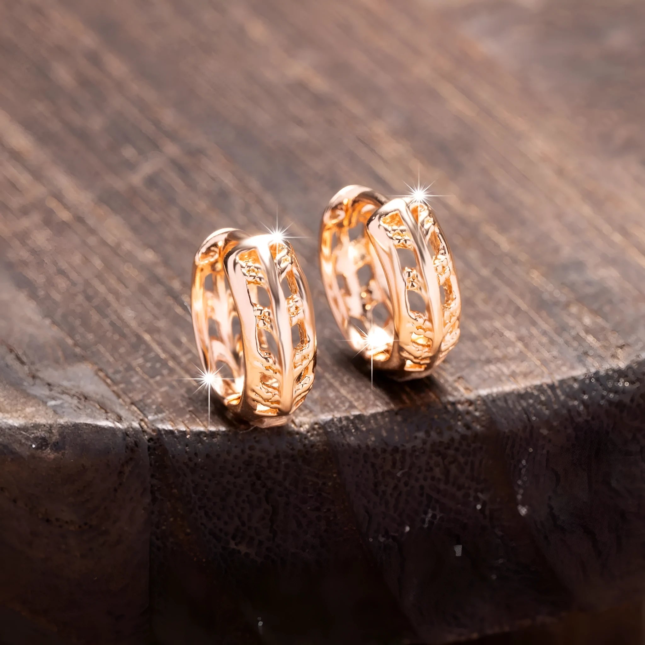 Rose gold hollowed copper earrings in leaf and heart shapes on a white background