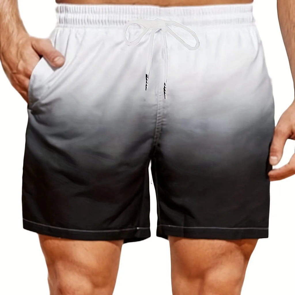 Man wearing grey gradient 3D printed mesh sports shorts against a plain background.