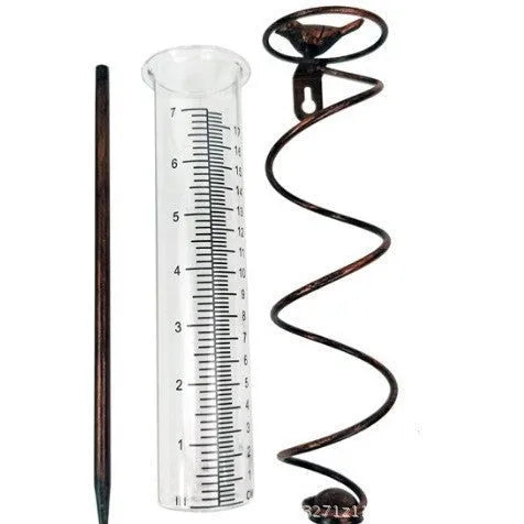 Cast iron outdoor rain gauge with glass hummingbird decoration showing measurement scale