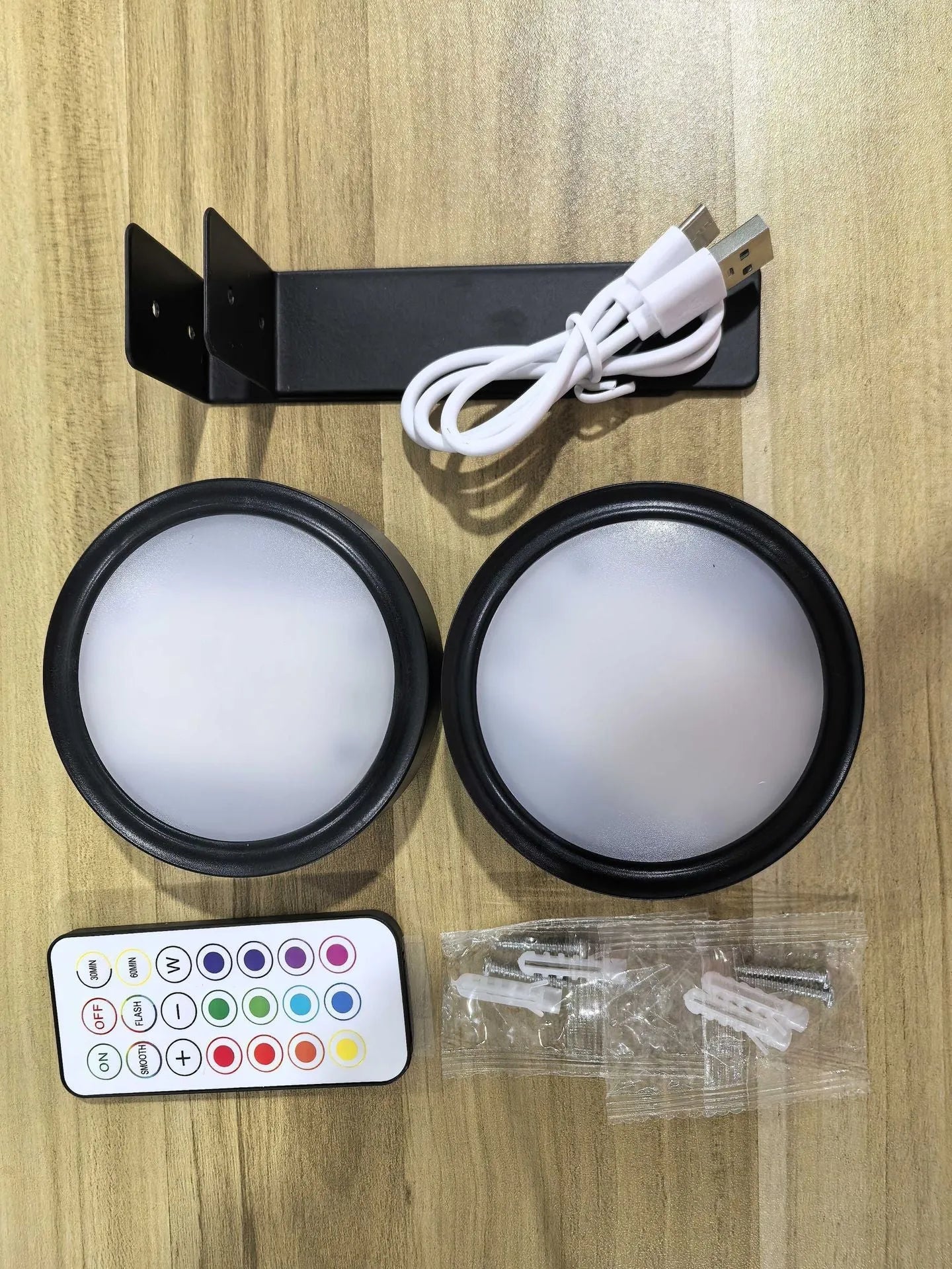 Wireless LED painting lamp with a magnetic mounting belt and remote control in black finish.