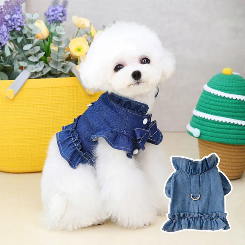 Blue denim dog dress with chest ruffles and a leash hook on the back, shown in dark blue and light blue.
