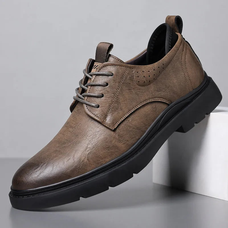 Men's black and brown leather sneakers with rubber sole and decorative sewing line detailing on cowhide upper