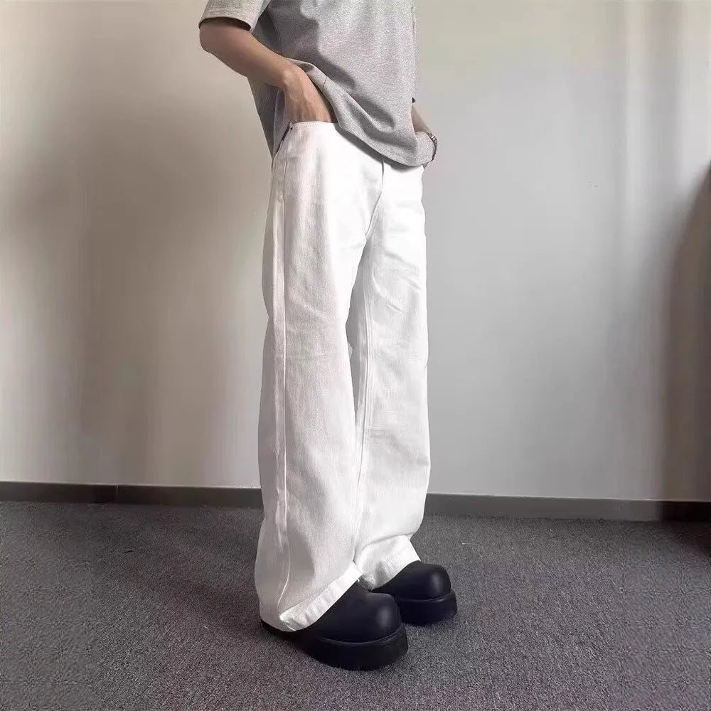 Men's white straight-leg denim jeans with a mid waist and zipper fly on a neutral background.