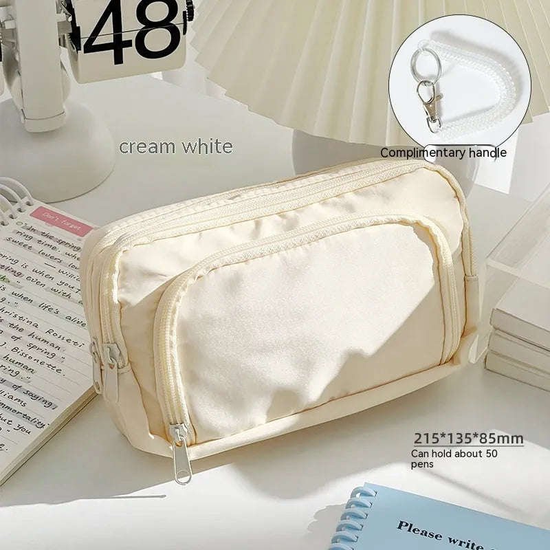 Double-layer pencil case in blue showing internal compartments and a top carry handle