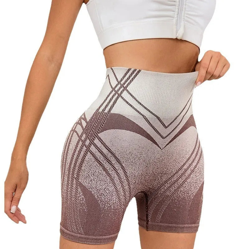 Women's high waisted gradient fitness shorts in black, shown with Spider-Man graphic.