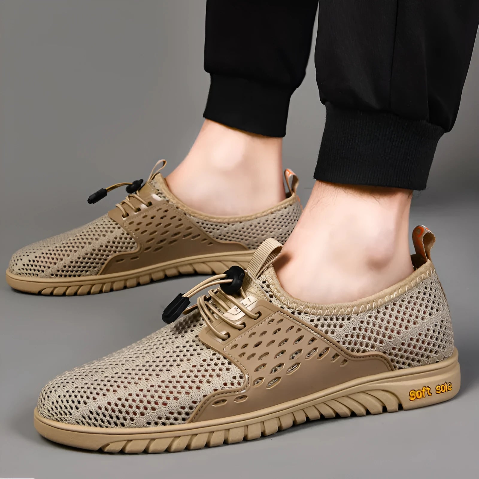 Men's grey mesh casual slip-on shoes with elastic band and rubber sole.