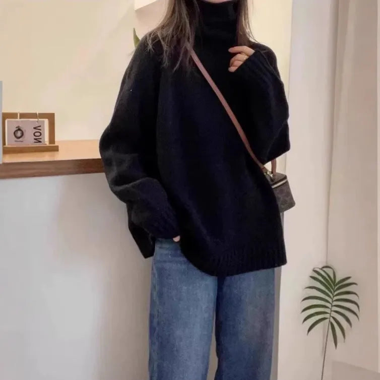 Women's loose grey turtleneck sweater with a thick, textured curling pile collar