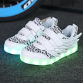 Children's plum red and white LED light up sneakers with USB charging port visible