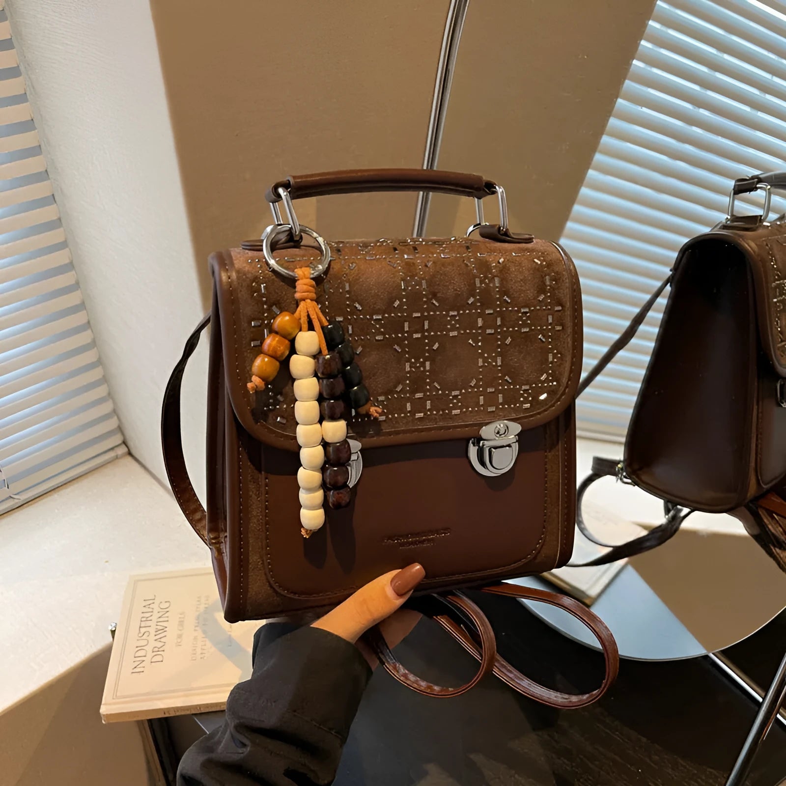 Small square PU leather messenger backpack for women with texture finish in black colour