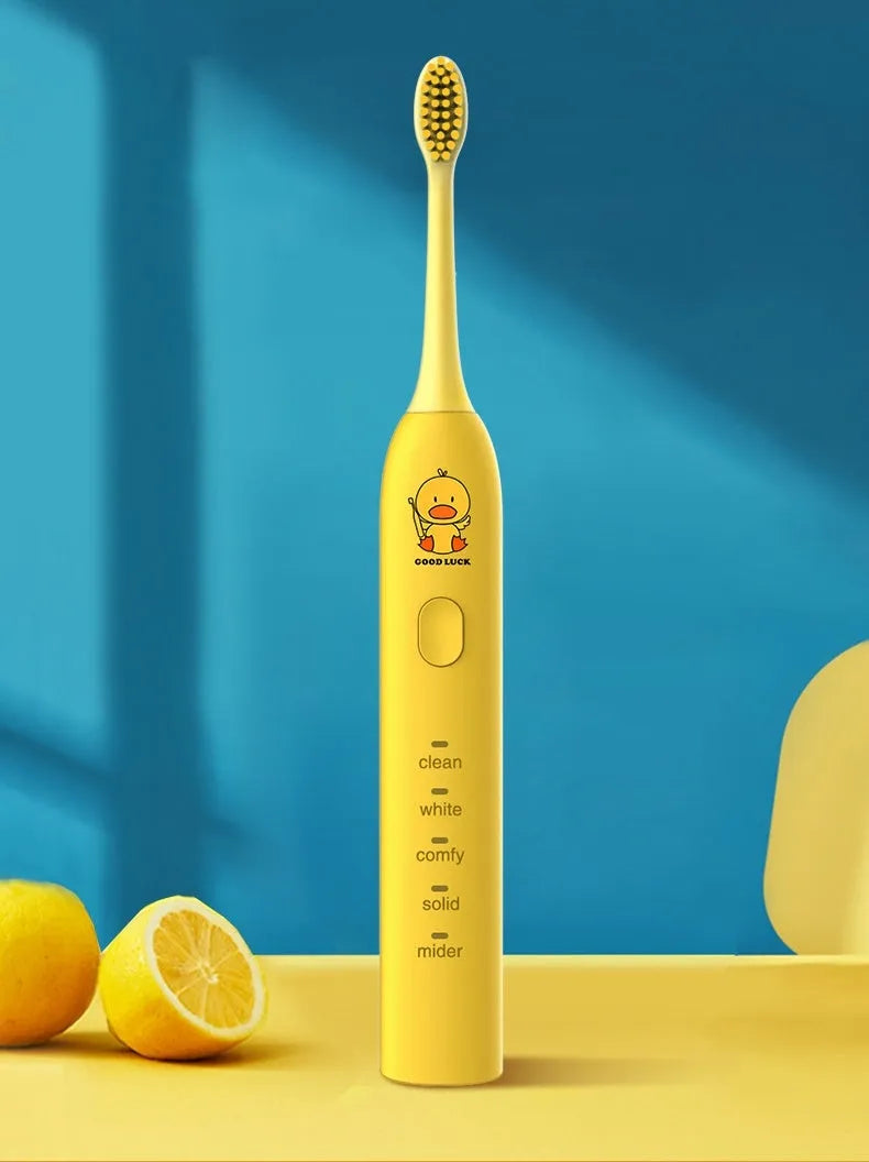 Small Yellow Duck rechargeable electric toothbrush in yellow, showing soft bristle head and USB port.