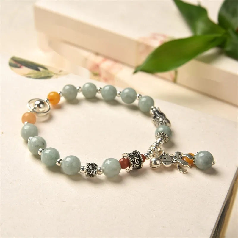 Natural emerald green vintage bracelet with jade stones on an alloy band, showing retro hand-crafted design.
