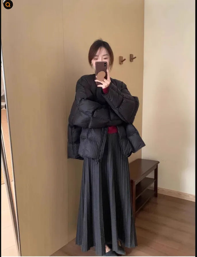 Dark grey knitted two-piece suit with 3D textured patterns, showing sweater and matching skirt
