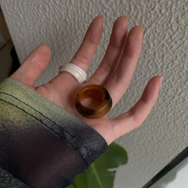 Chinese style irregular geometric resin wide ring in neutral colours on display