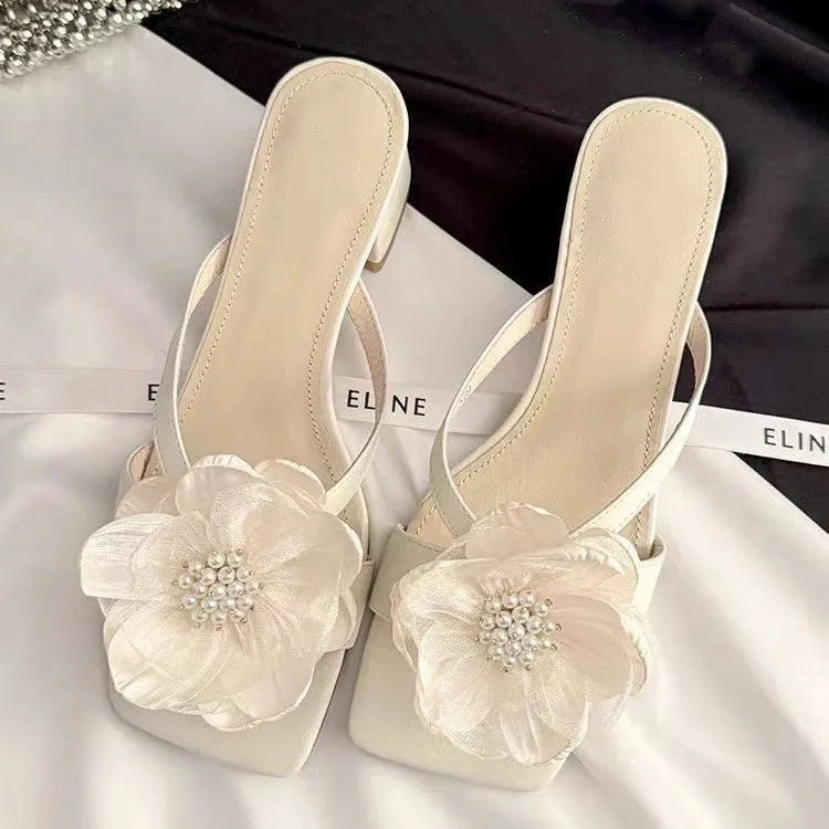Women's cream-white satin sandals with a chunky block heel, square toe, and a single strap across the foot.