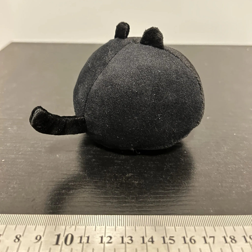 Black cat plush toy with fluffy fur and cushion design for napping