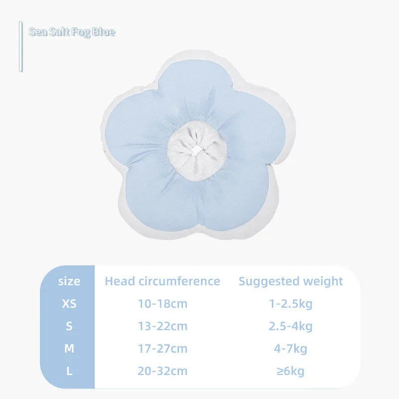 Blue cotton cat recovery collar with a solar flower decoration, shown fastened around a cat's neck.