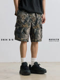 Man wearing loose straight-leg denim shorts in army green, showing mid waist and casual style.
