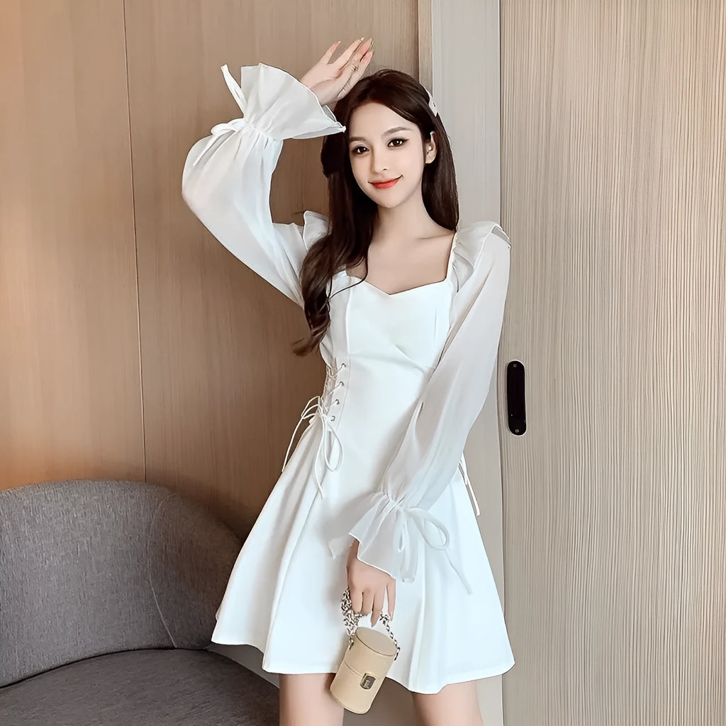 White long sleeve chiffon patchwork dress with a slim waist and floor-length skirt on a woman.