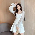 White long sleeve chiffon patchwork dress with a slim waist and floor-length skirt on a woman.